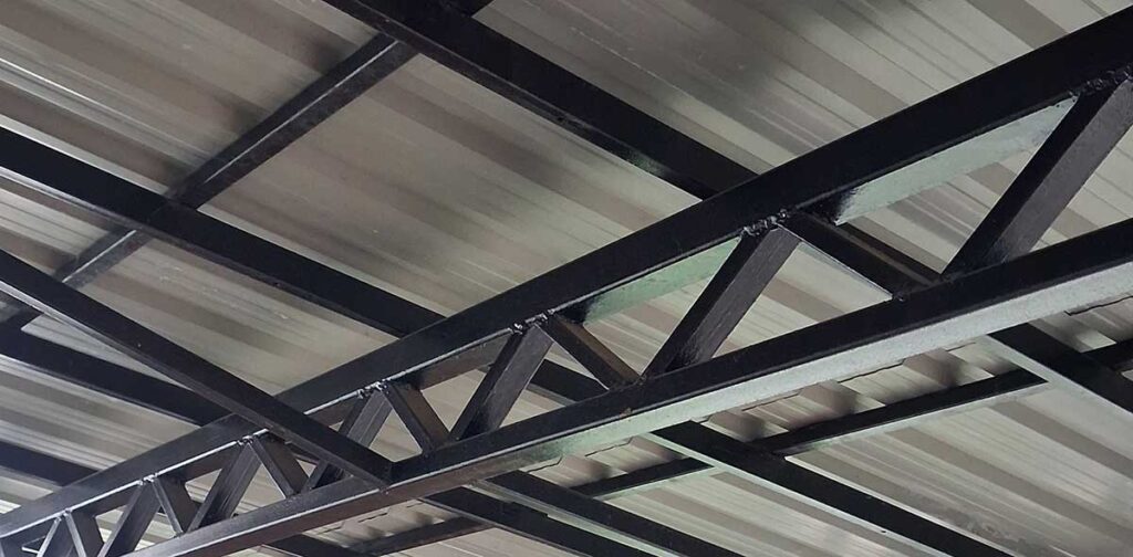 Steel square tubing frame supporting metal roofing panels on porch structure